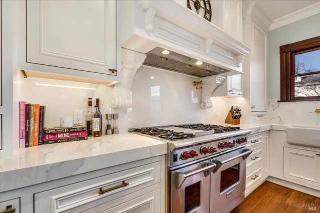 a kitchen with stainless steel appliances granite countertop a stove and a sink
