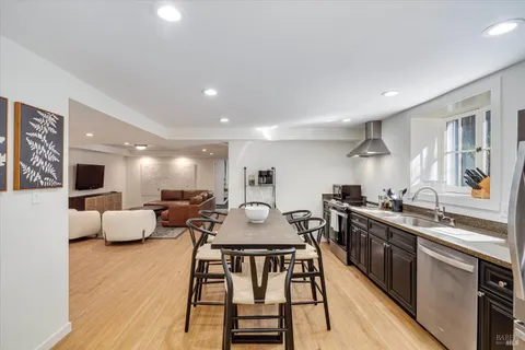 a view of a patio with couches table and chairs and potted plants