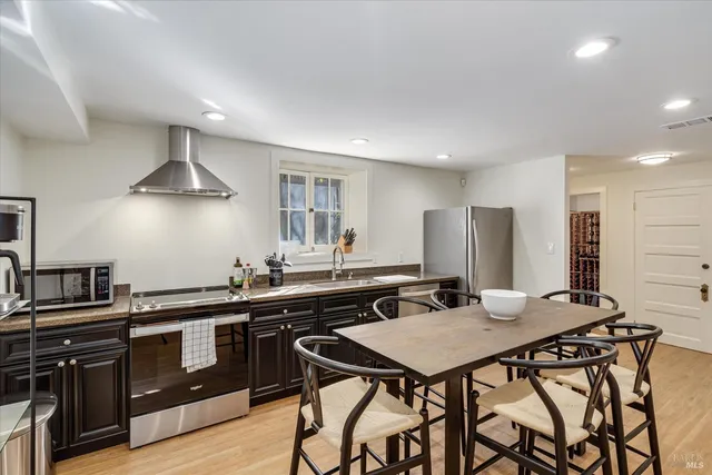 a view of outdoor sitting area with furniture and wooden fence