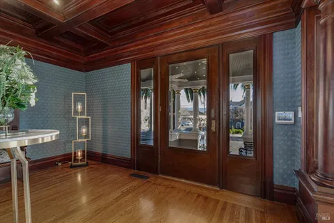a living room with furniture a chandelier and a fireplace
