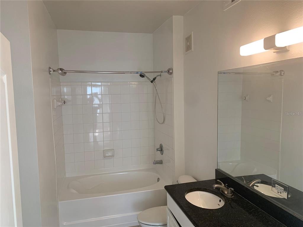 5255 Cane Island Loop, Unit 304 Kissimmee, FL 34746 - Photo 7 of 14 a bathroom with a sink a toilet and shower