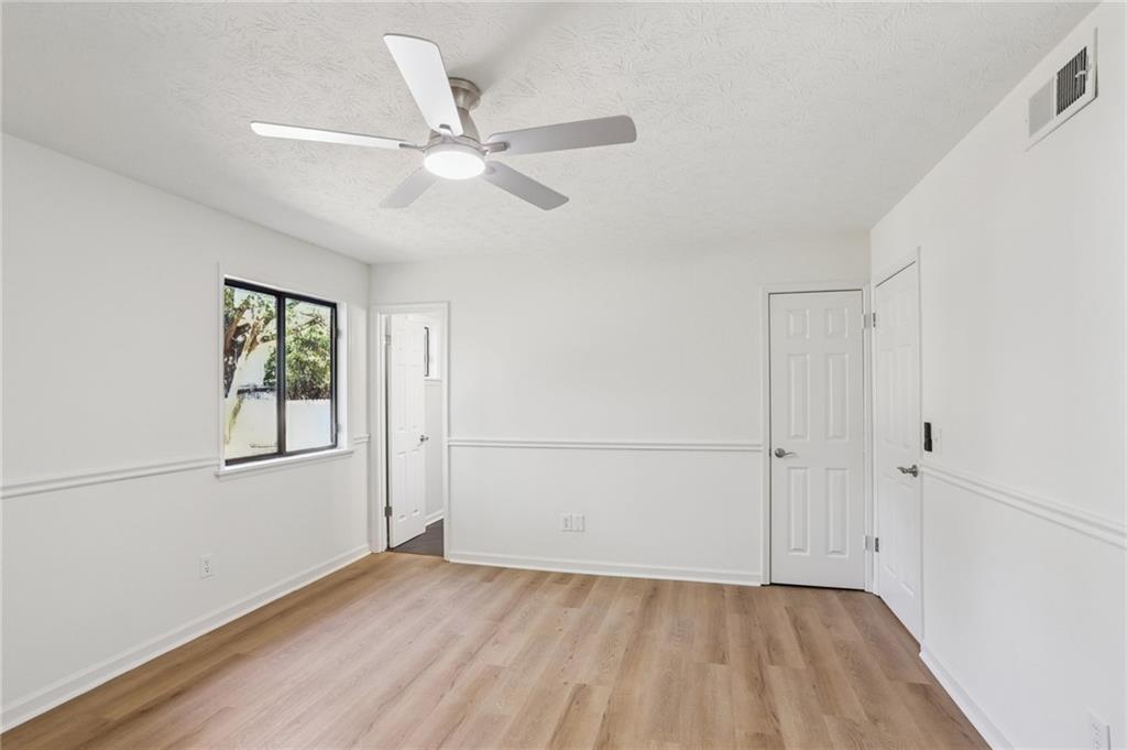 5457 Rails Way Norcross, GA 30071 - Photo 15 of 30 a view of an empty room with a window and wooden floor