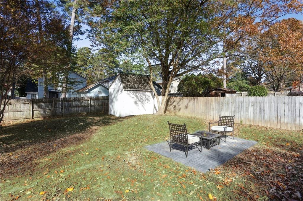 5457 Rails Way Norcross, GA 30071 - Photo 22 of 30 a view of a backyard with a patio and fire pit