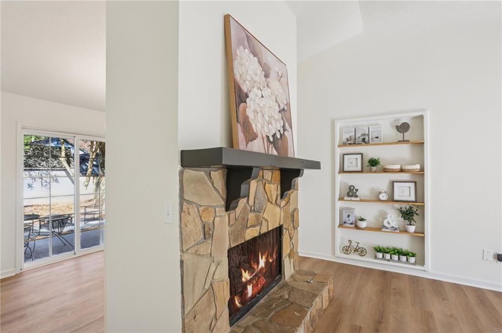 5457 Rails Way Norcross, GA 30071 - Photo 6 of 30 a room with painting on the wall and a fireplace