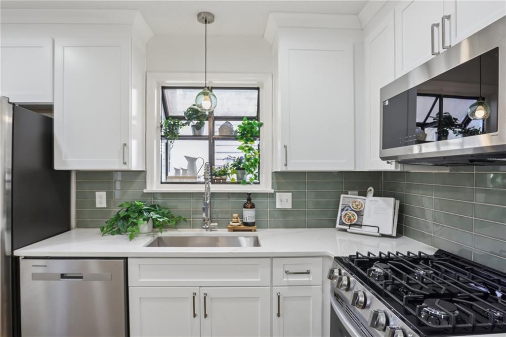 5457 Rails Way Norcross, GA 30071 - Photo 10 of 30 a kitchen with stainless steel appliances a sink stove and cabinets