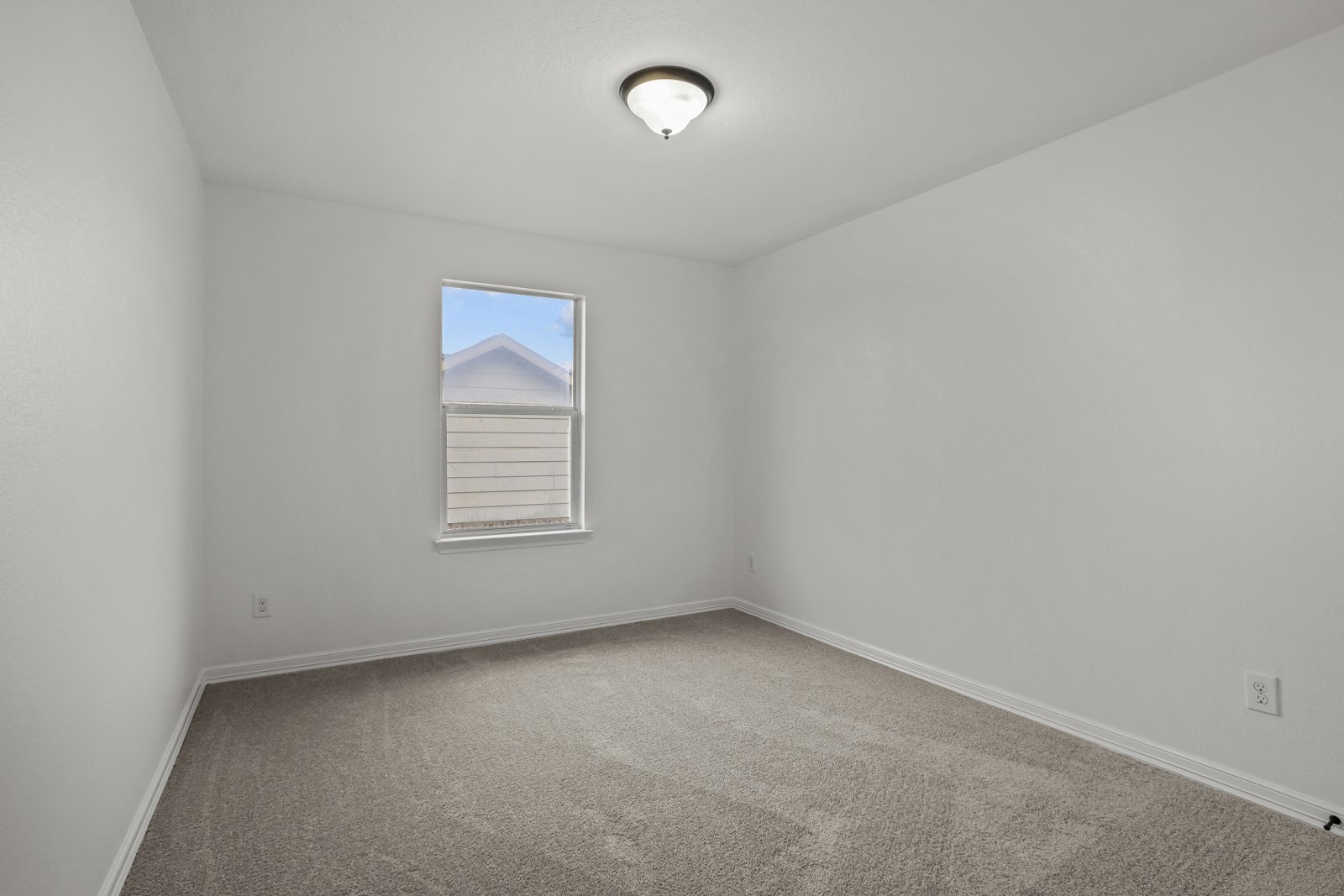 245 Razzmatazz Trail Buda, TX 78610 - Photo 27 of 37 Neutral wall paint and carpeting highlight this room