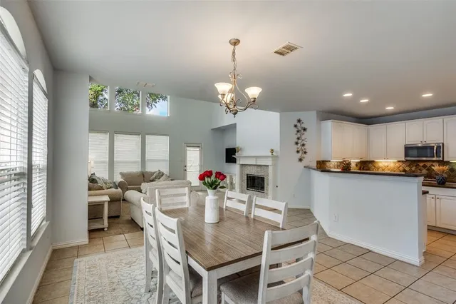 a kitchen with kitchen island granite countertop a sink cabinets and living room view