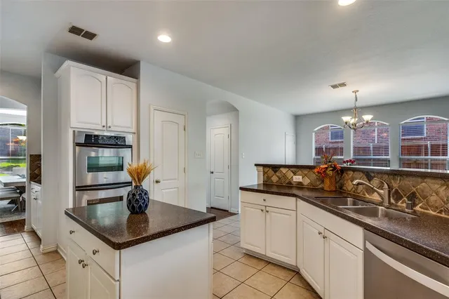 a kitchen with counter top space a sink and appliances