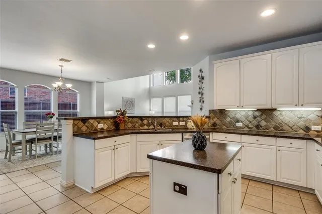 a kitchen with granite countertop a sink and cabinets