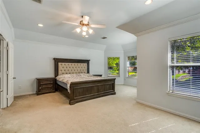 a spacious bedroom with a bed and a chandelier
