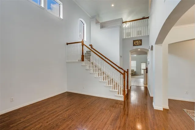 a view of entryway and hall with wooden floor