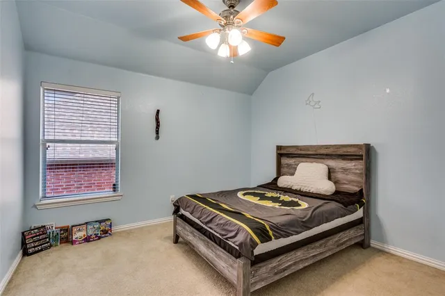 a bed sitting in a bedroom next to a window