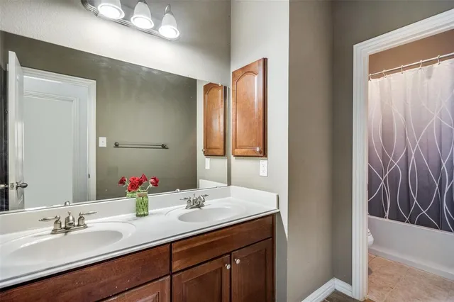 a bathroom with a double vanity sink and a mirror