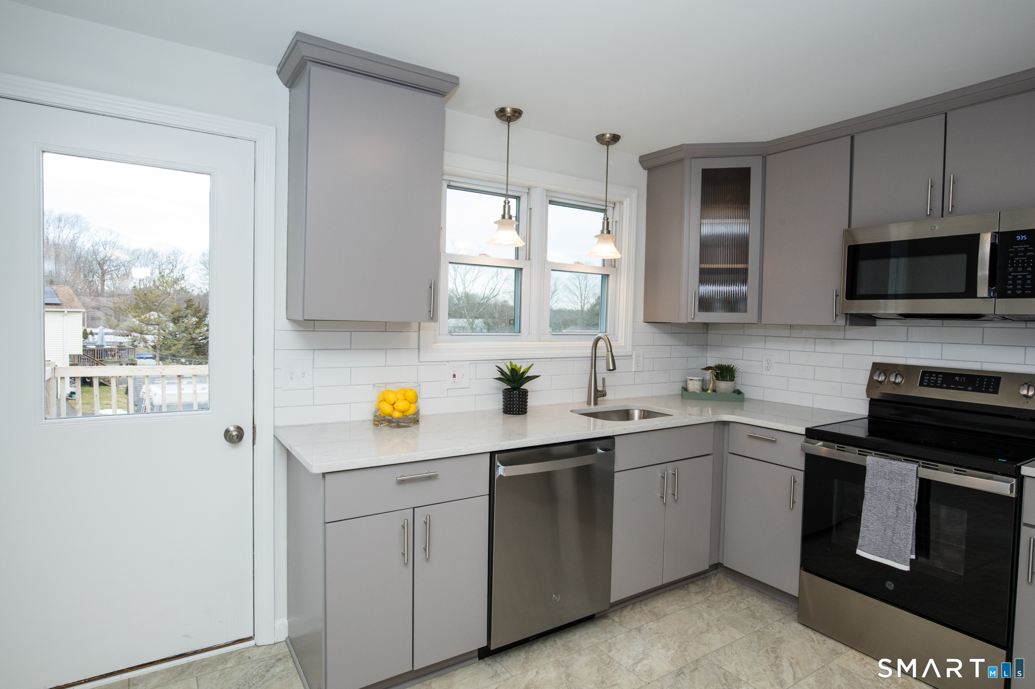291 Cartpath Drive Meriden, CT 06450 - Photo 4 of 30 a kitchen with a sink a stove and cabinets