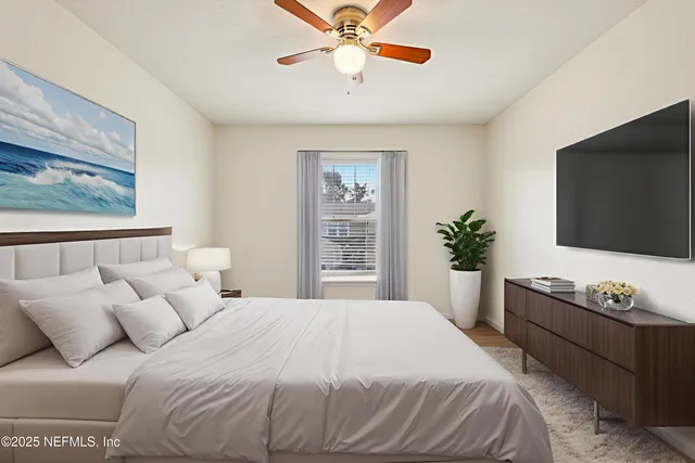 a bedroom with a bed and a flat screen tv