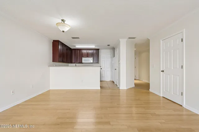 a view of a kitchen with a sink and cabinets
