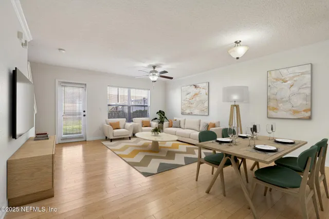 a living room with couches a coffee table and a flat screen tv