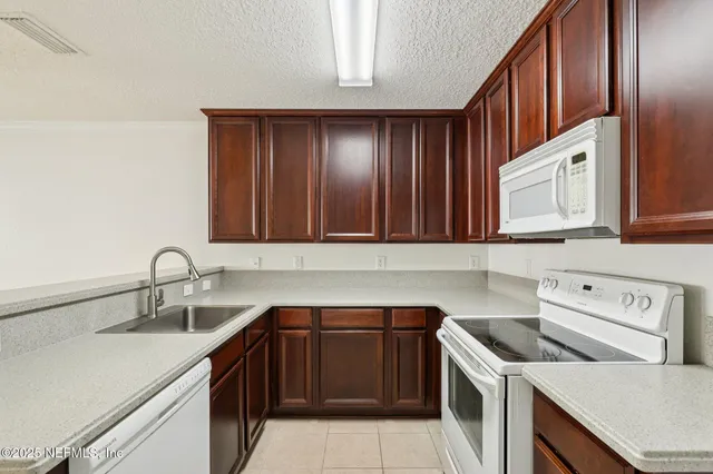 a kitchen with a sink cabinets and stainless steel appliances