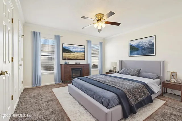 a spacious bedroom with a bed and a chandelier