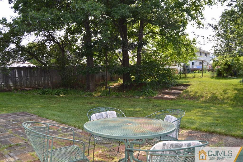 4 Montview Road Edison, NJ 08837 - Photo 22 of 25 a backyard of a house with yard fountain and outdoor seating