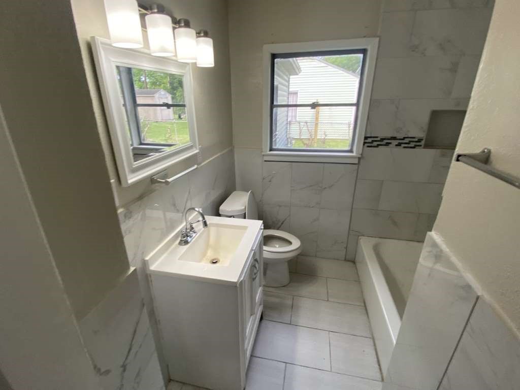 5715 Belmark Street Houston, TX 77033 - Photo 8 of 13 a bathroom with a sink toilet and tub
