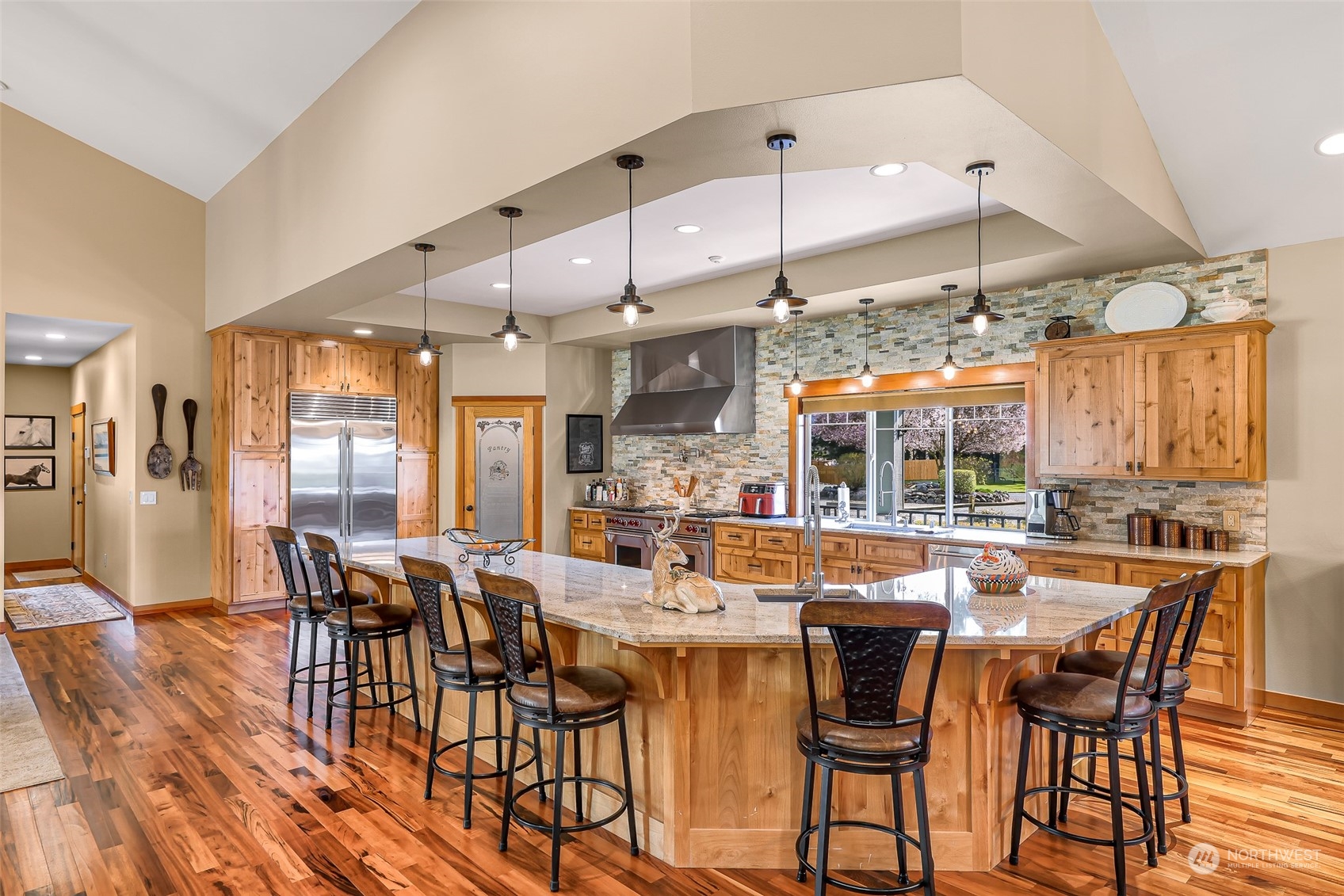 3678 Osgood Road Everson, WA 98247 - Photo 16 of 40 a dining room with stainless steel appliances kitchen island granite countertop a table chairs and a refrigerator