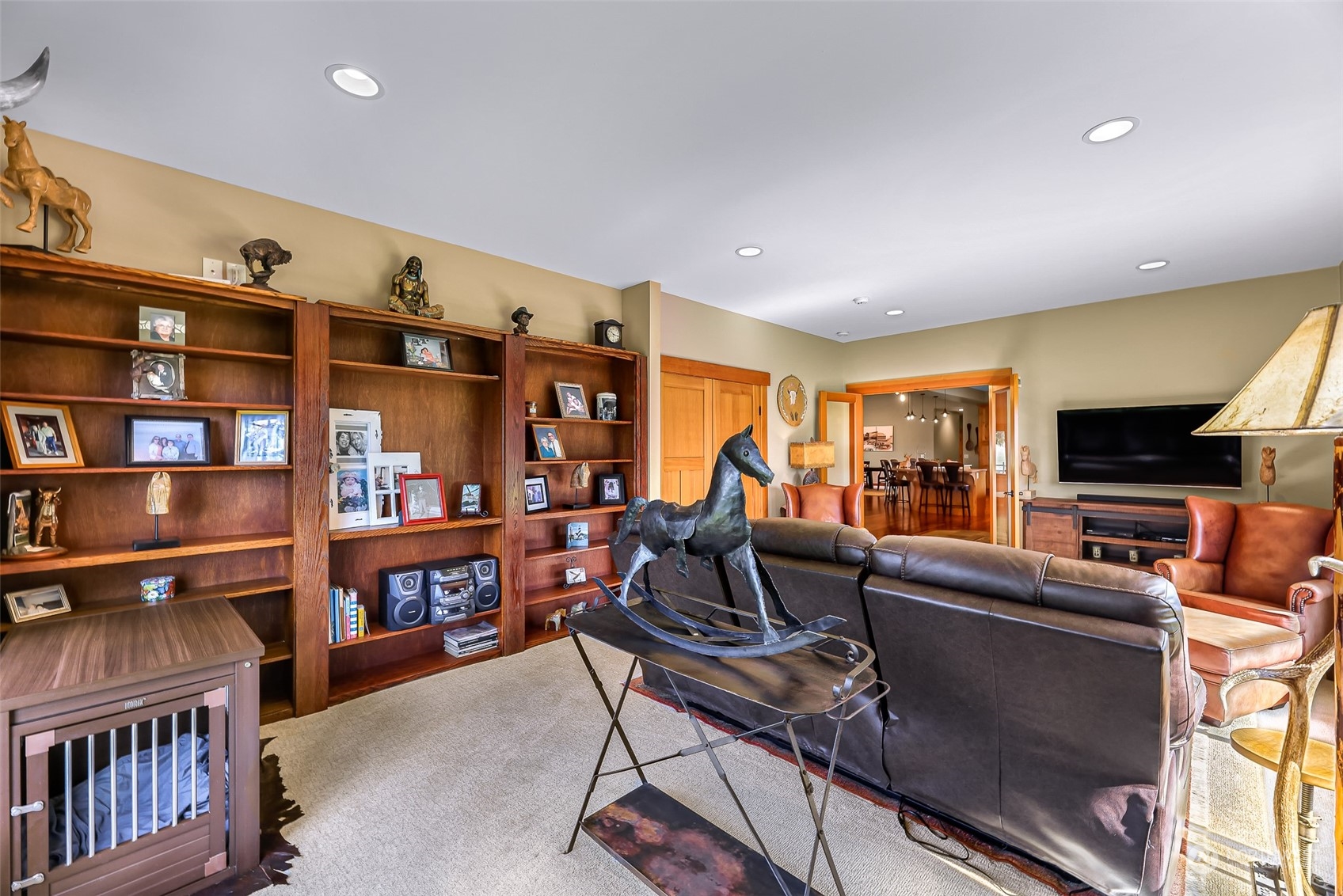 3678 Osgood Road Everson, WA 98247 - Photo 26 of 40 a living room with furniture a flat screen tv and a bookshelf