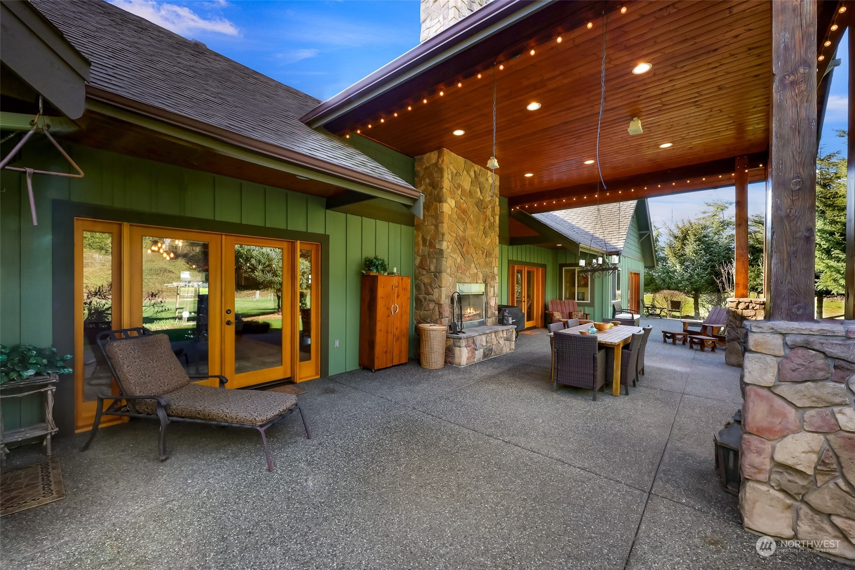 3678 Osgood Road Everson, WA 98247 - Photo 32 of 40 a view of a patio with dining table and chairs under an umbrella with a patio
