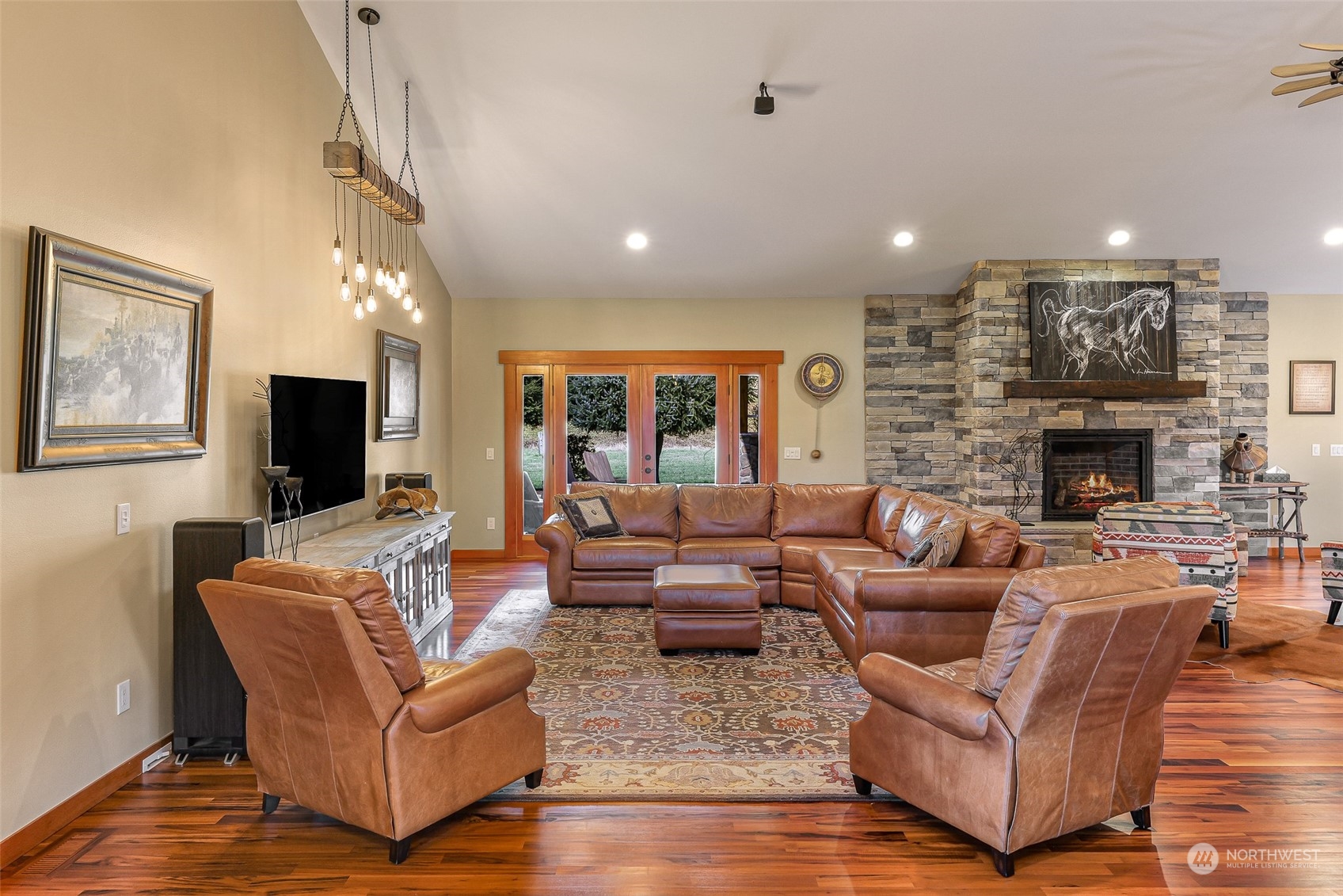 3678 Osgood Road Everson, WA 98247 - Photo 7 of 40 a living room with furniture a flat screen tv and a fireplace