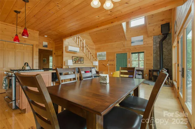a dining room with furniture and a floor to ceiling window