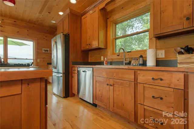 a kitchen with cabinets a sink and appliances