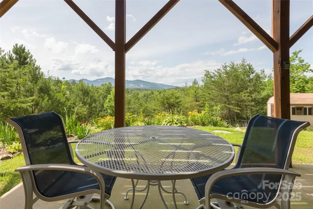 a view of a porch with furniture and a backyard