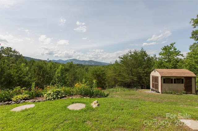 a view of a backyard with table and chairs and potted plants