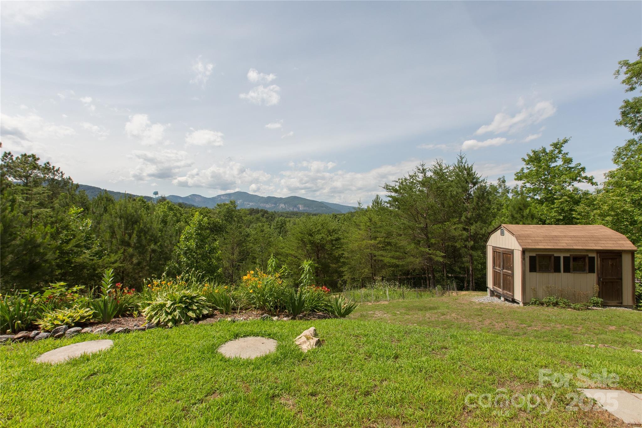 206 Legend Dr Mill Spring Mill Spring, NC 28756 - Photo 24 of 48 a view of a backyard with table and chairs and potted plants