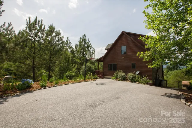 a view of a house with a tree and pathway
