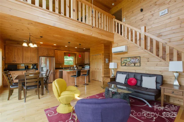 a living room with furniture a rug and a chandelier