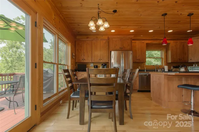 a view of a dining room with furniture and chandelier