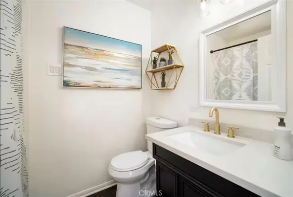 a bathroom with a sink mirror and toilet