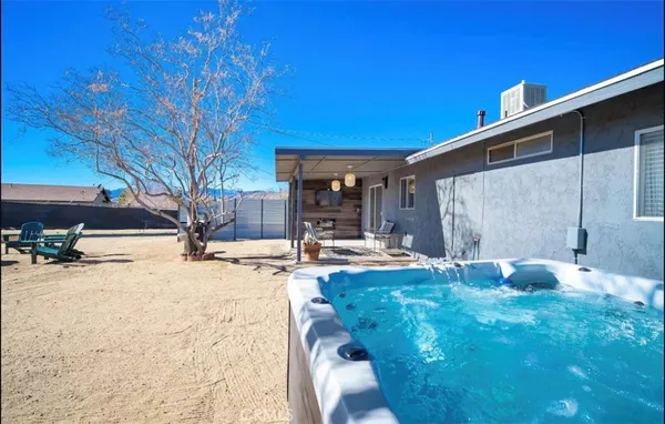 a swimming pool with outdoor seating