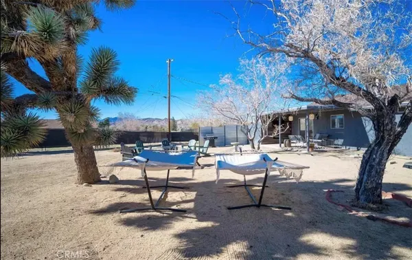 a view of a backyard with swimming pool