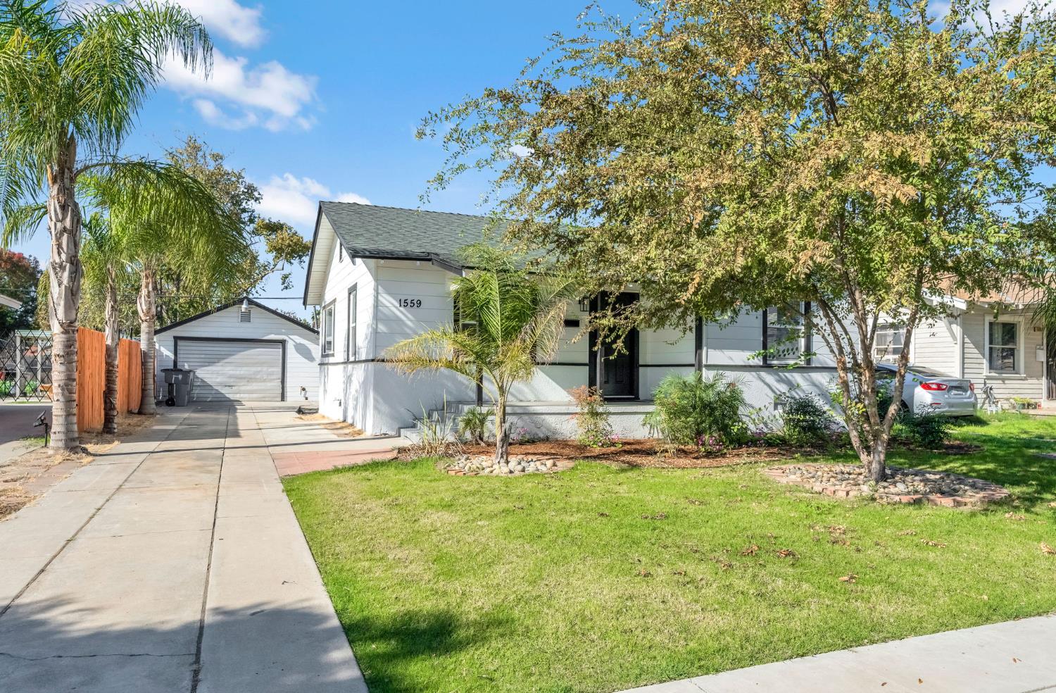 1559 North Carruth Avenue Fresno, CA 93728 - Photo 1 of 24 a front view of a house with garden