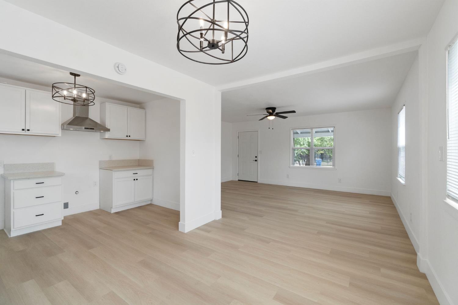 1559 North Carruth Avenue Fresno, CA 93728 - Photo 11 of 24 wooden floor in an empty room and a window