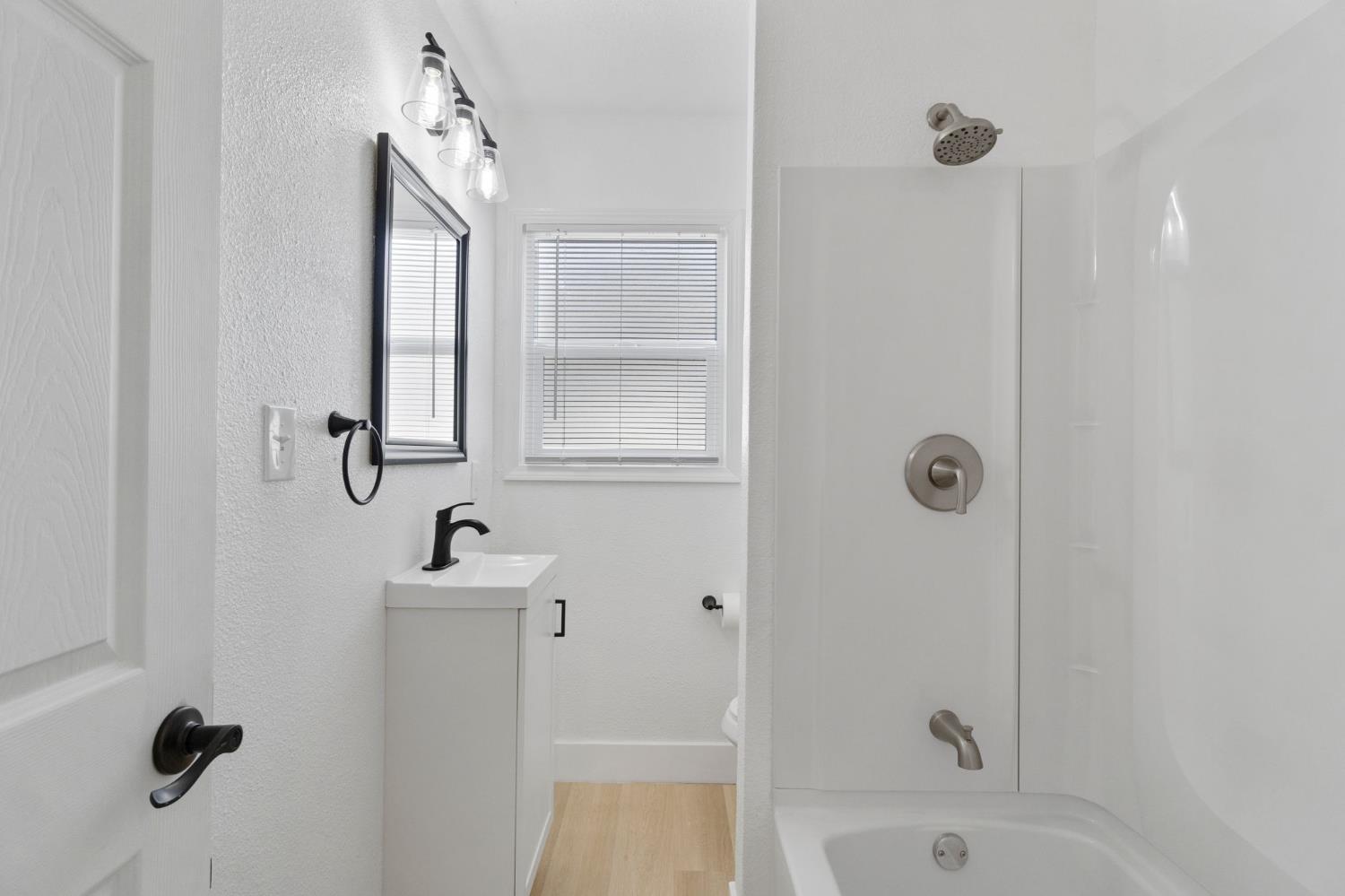 1559 North Carruth Avenue Fresno, CA 93728 - Photo 17 of 24 a bathroom with a sink a window and shower