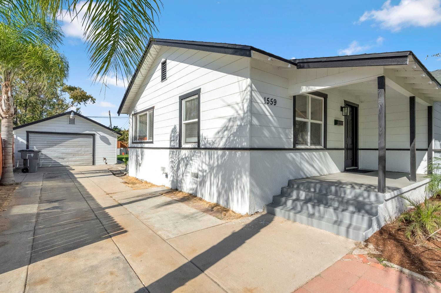 1559 North Carruth Avenue Fresno, CA 93728 - Photo 4 of 24 a view of a white house with a large windows