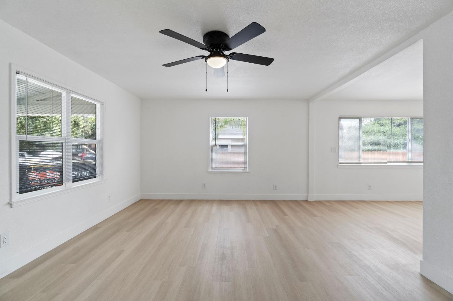 1559 North Carruth Avenue Fresno, CA 93728 - Photo 6 of 24 a view of an empty room with wooden floor and a window