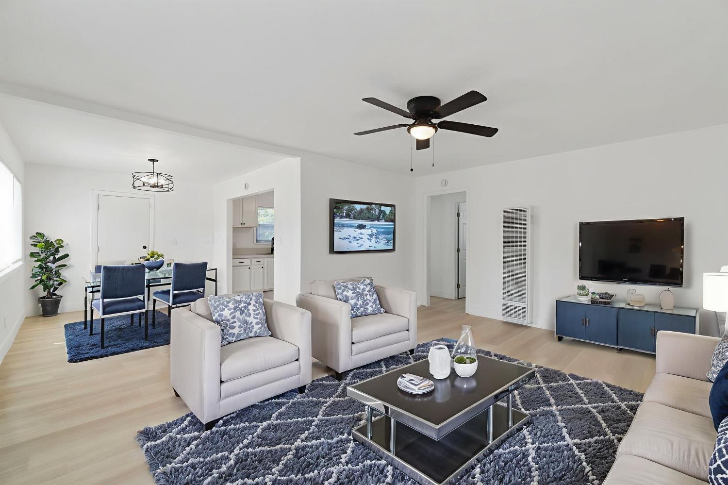 1559 North Carruth Avenue Fresno, CA 93728 - Photo 8 of 24 a living room with furniture a rug and a flat screen tv