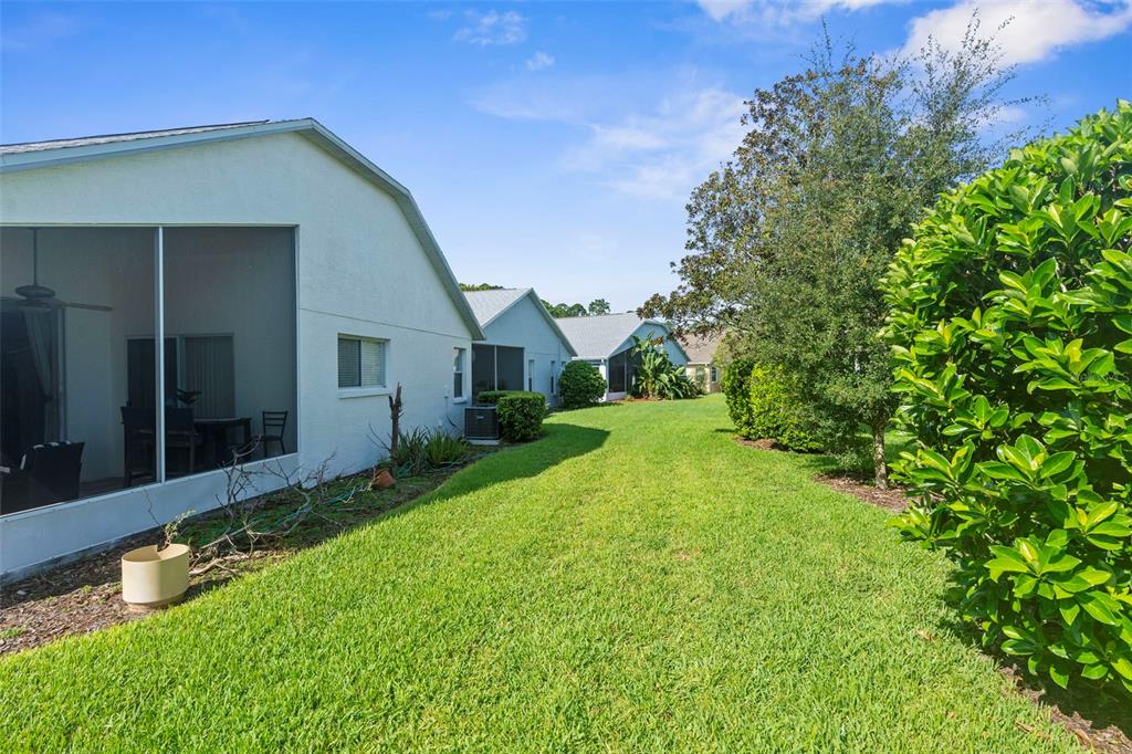 11847 Spindrift Loop Hudson, FL 34667 - Photo 27 of 28 a front view of a house with garden