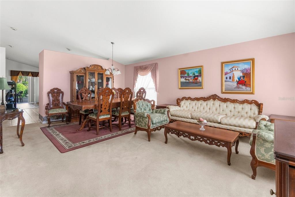 11847 Spindrift Loop Hudson, FL 34667 - Photo 4 of 28 a living room with furniture and a dining table