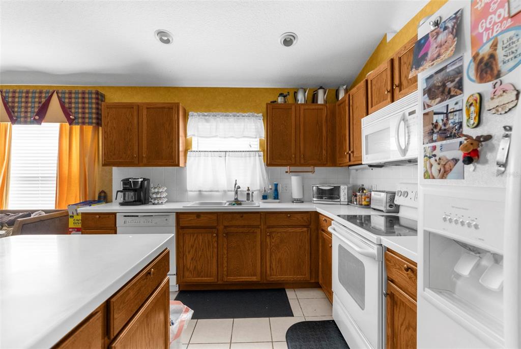 11847 Spindrift Loop Hudson, FL 34667 - Photo 7 of 28 a kitchen with a sink stove and cabinets
