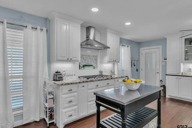 a kitchen with a sink a stove and cabinets